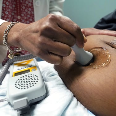 A doctor uses a hand-held Doppler probe on a pregnant woman to measure the heartbeat of the fetus on Dec. 17, 2021, in Jackson, Miss. (AP Photo/Rogelio V. Solis, File)