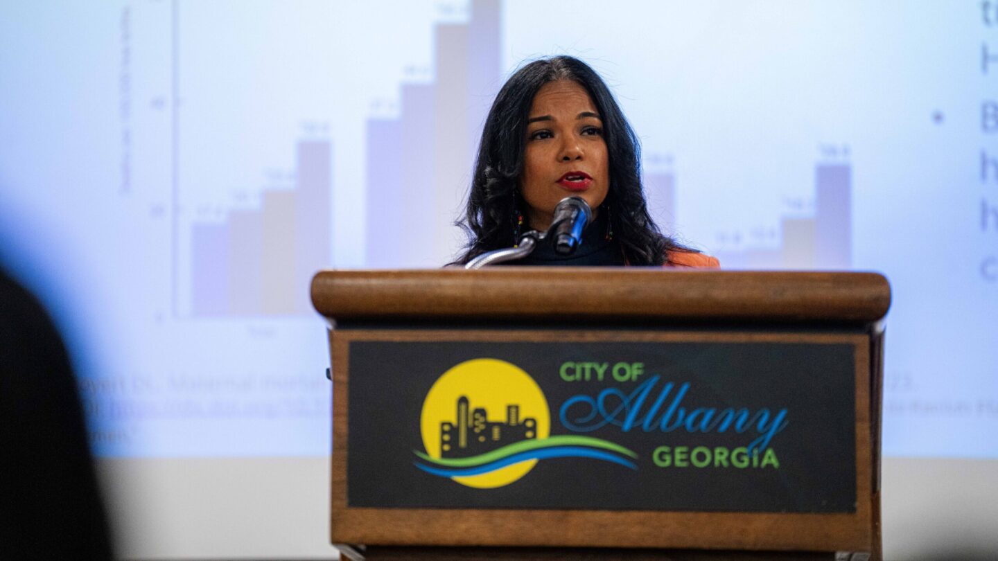 Woman at podium speaking