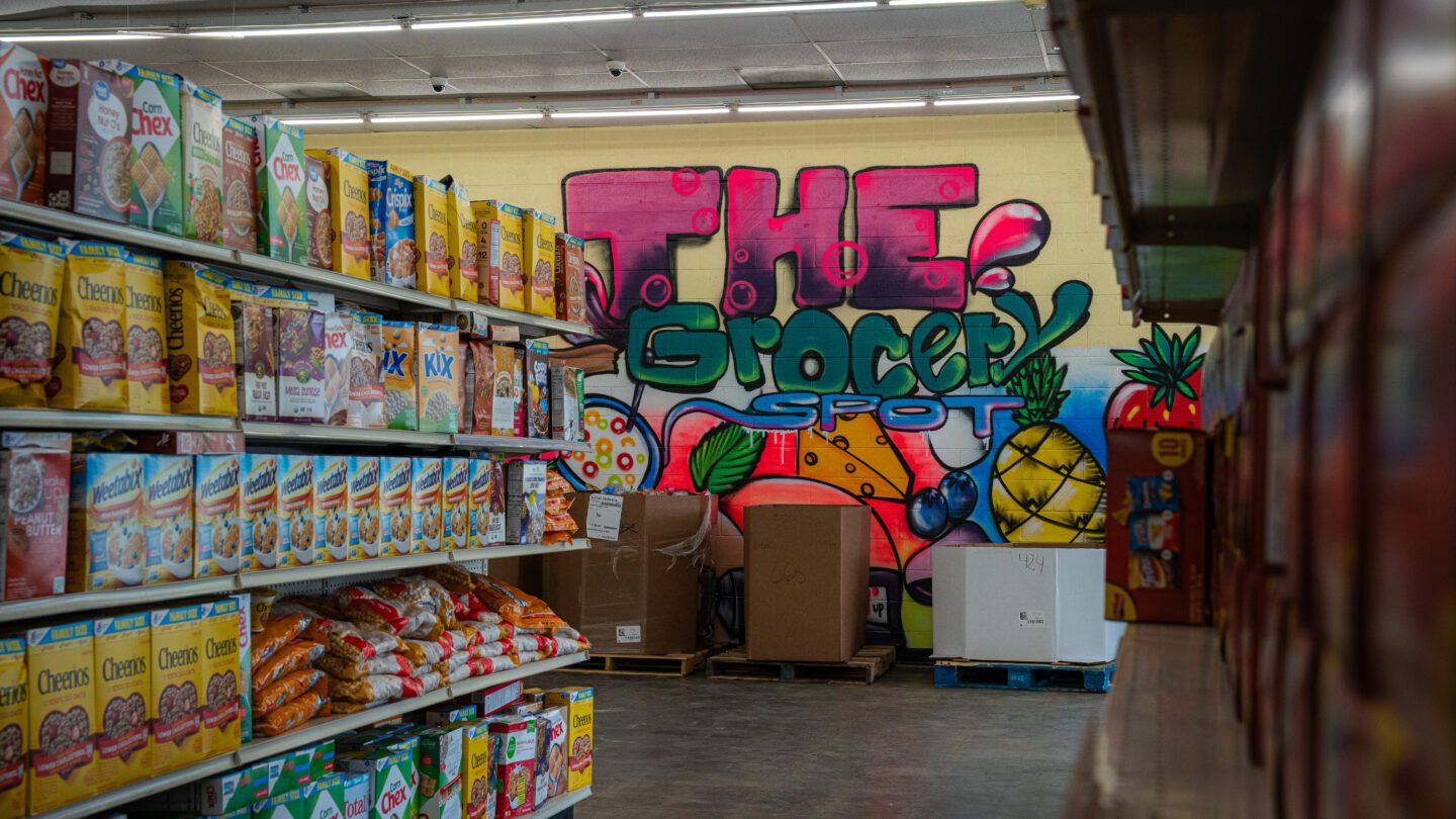 A grocery aisle with rows of cereal boxes and a colorful backdrop.