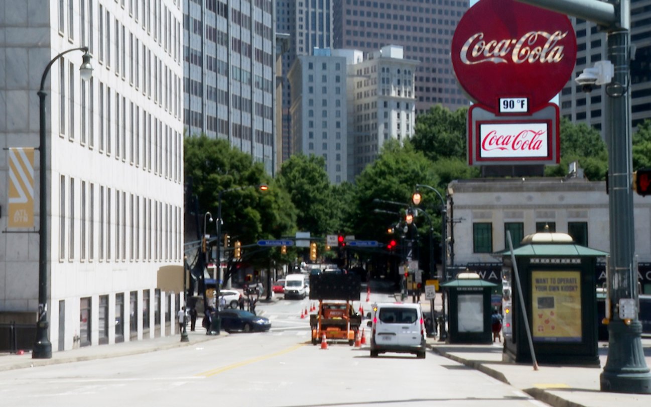 A view shows Peachtree Street in Atlanta on June 10, 2022. A large Coca-Cola sign stands in the far right corner of the photo.