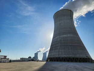 A thick funnel emits steam into a blue sky at Plant Vogtle in Waynesboro, Georgia, a four-unit nuclear power plant.