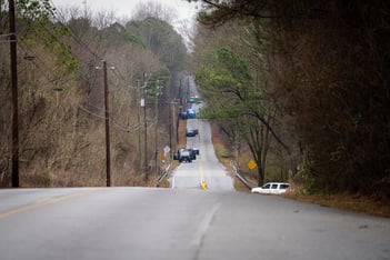 Multiple law enforcement agencies form a perimeter along Constitution Rd after a Trooper was shot and a protester was killed in the Atlanta Forest.