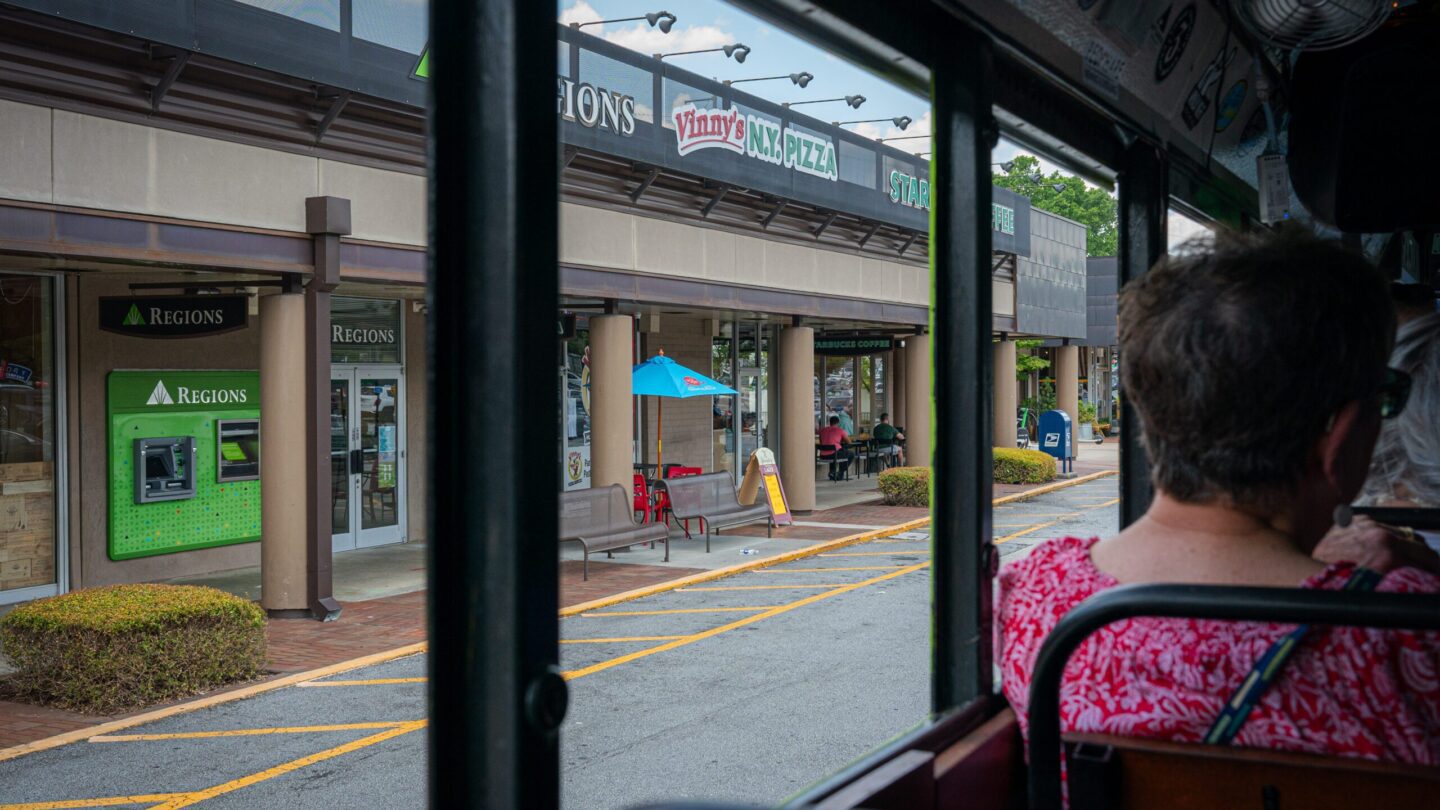 Photo of stores through bus window