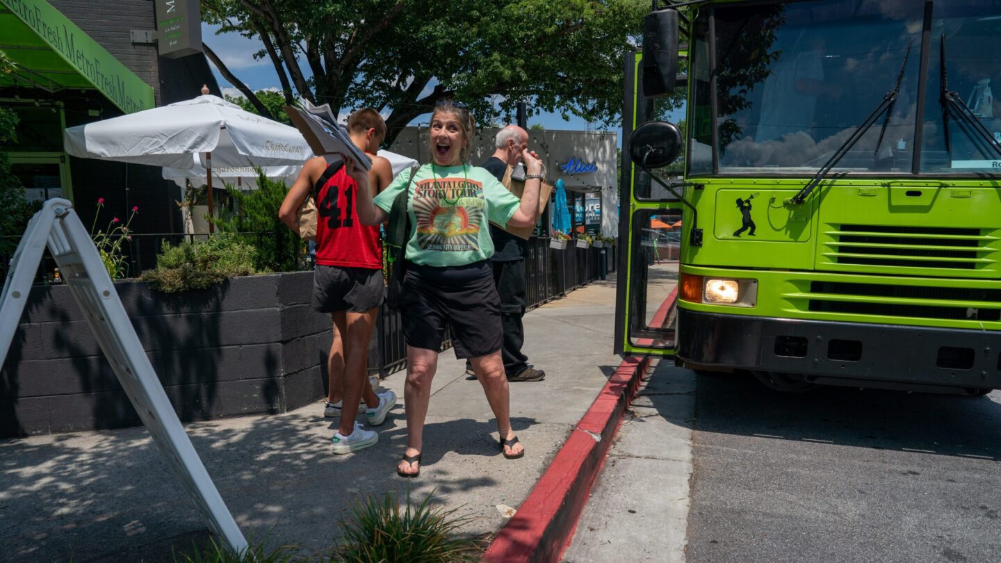 Proud woman in front of bus