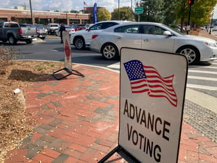 A sign showing the way for voters stands outside a Cobb County voting building during the first day of early voting, Monday, Oct. 17, 2022, in Marietta, Georgia.