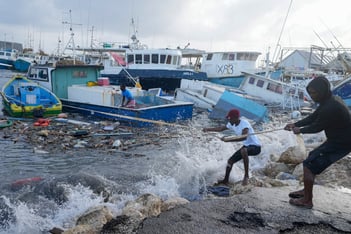 Hurricane Beryl roared through open waters on Tuesday as a monstrous Category 5 storm on a path that would take it near Jamaica and the Cayman Islands after earlier making landfall in the southeast Caribbean, killing at least four people.