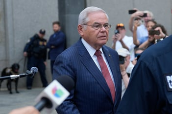 New Jersey Senator Bob Menendez is leaving federal court in New York, and microphones and cameras are pointed at him as he leaves.