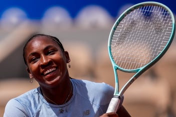 Coco Gauff of the U.S. attends a practice session ahead of the tennis competition, at the 2024 Summer Olympics, Thursday, July 25, 2024, in Paris, France. She is smiling and holding a tennis racket.