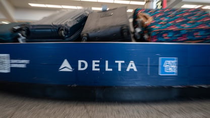 A blue Delta baggage claim carousel