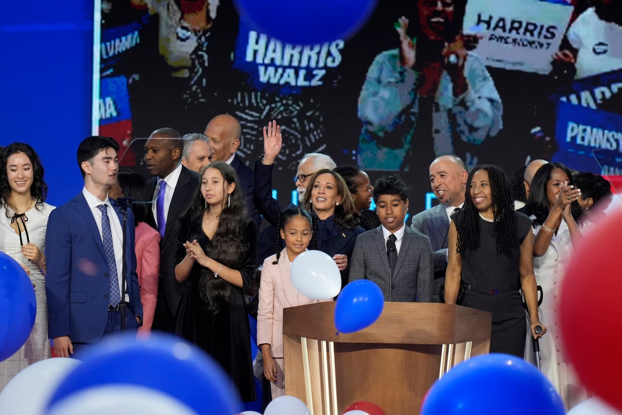 Democratic presidential nominee Vice President Kamala Harris, center, hugs her grand-niece Amara Ajagu surrounded by family during the Democratic National Convention Thursday, Aug. 22, 2024, in Chicago.