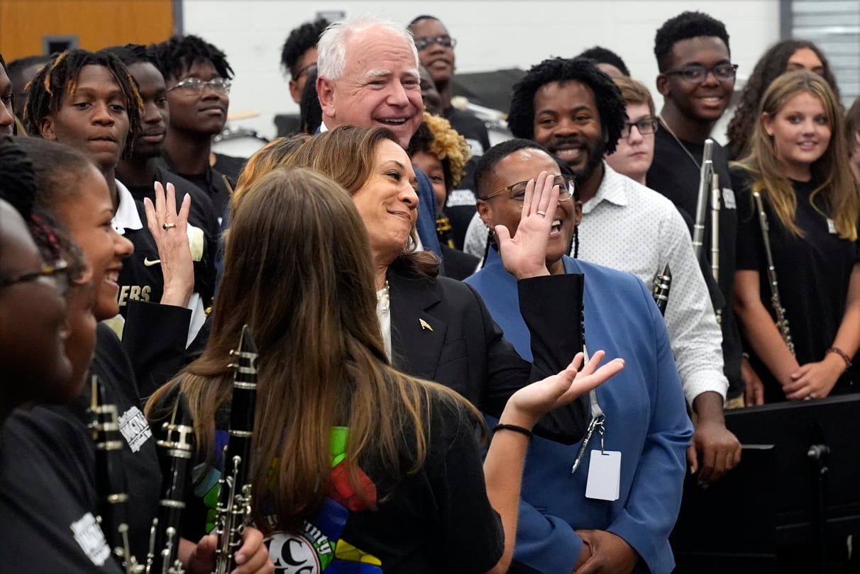Democratic presidential nominee Vice President Kamala Harris and Democratic vice presidential candidate Minnesota Gov. Tim Walz poses for a photo with marching band members at Liberty County High School in Hinesville, Ga.