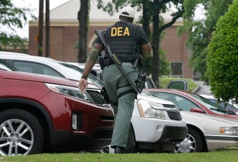 A Drug Enforcement Administration officer patrols outside of a medical clinic in Little Rock, Ark