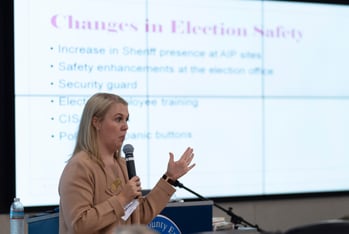 Tate Fall, director of Cobb County Elections, speaks in front of a projected slide during an election security training session at Cobb County Emergency Management headquarters Aug. 23, 2024, in Marietta.