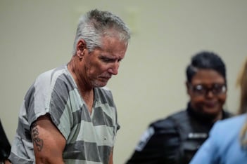 Colin Gray appears in the Barrow County courthouse. He looks toward the ground.