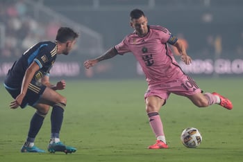 Lionel Messi kicks ball away from Leon Flach during MLS soccer match in Florida.