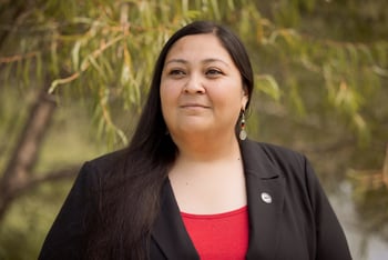 RaeLynn Butler, a Muscogee Nation citizen and one of its tribal historic preservation officers, poses for a photo outside.
