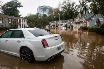 A car is partially submerged in water in a neighborhood in Atlanta.