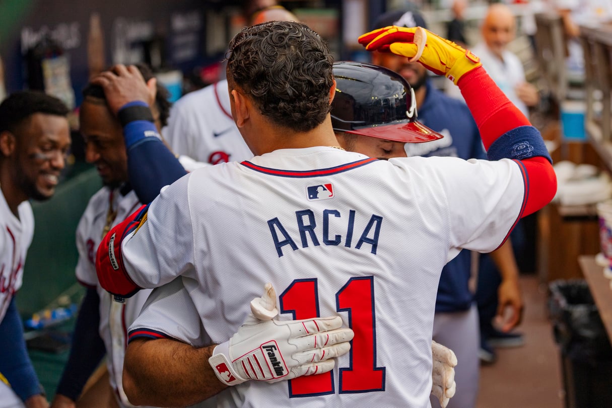 Atlanta Braves' Ramon Laureano, behind, hugs Atlanta Braves Orlando Arcia, front, in the dugout after hitting a solo home run to centerfield in the sixth inning of a baseball game against the New York Mets, Monday, Sept. 30, 2024, in Atlanta.