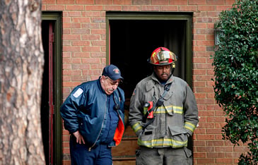 Fire officials standing outside of a building