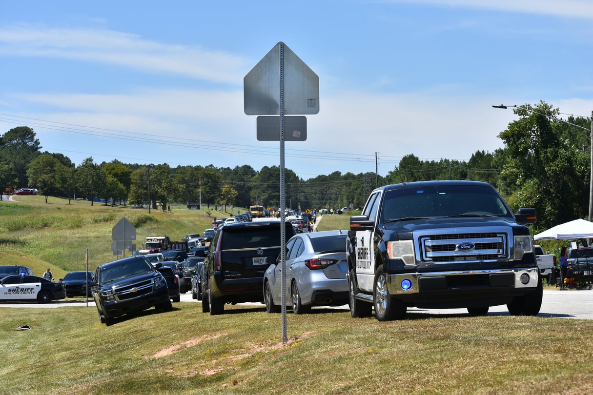 Cars park in a long line as parents arrive to pick up their students after a deadly shooting at Apalachee High School in Barrow County, Georgia, on Sept. 4, 2024.