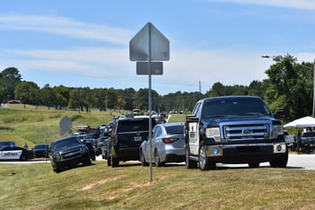 Cars park in a long line as parents arrive to pick up their students after a deadly shooting at Apalachee High School in Barrow County, Georgia, on Sept. 4, 2024.
