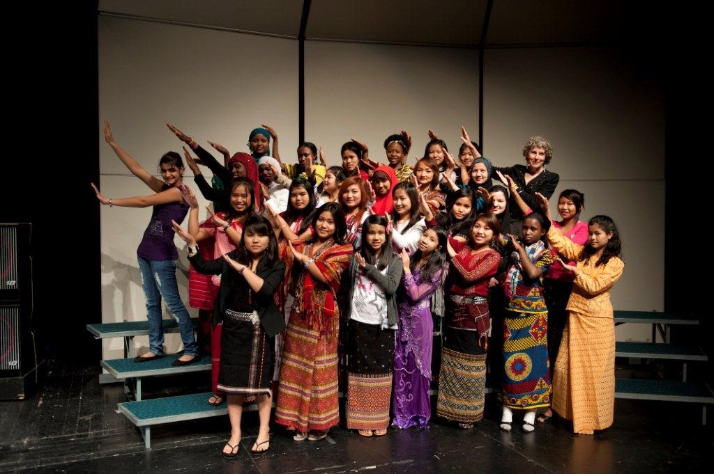 A group of students perform on stage.