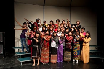 A group of students perform on stage.