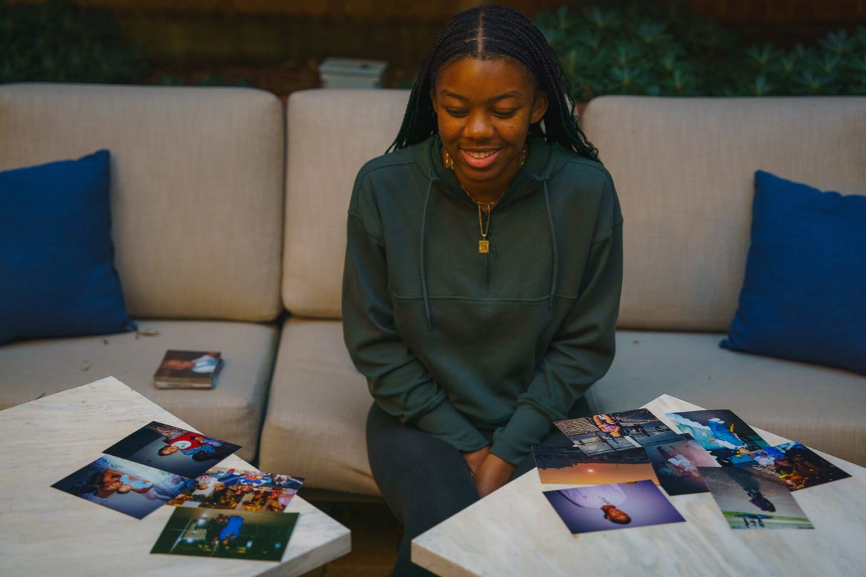 Marina Melendez looks at photos of her family