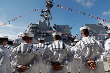 Sailors stand in front of a U.S. Navy guided missile destroyer USS Paul Ignatius at Port Everglades in Florida.