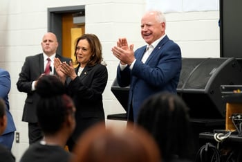 Kamala Harris, left, and Tim Walz, right clap during a band rehearsal.