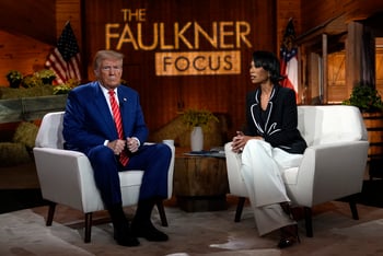 Donald Trump sits on a white armchair to the left, and journalist Harris Faulkner sits in a white armchair to the right. The Faulkner Focus logo is projected onto the wood background.
