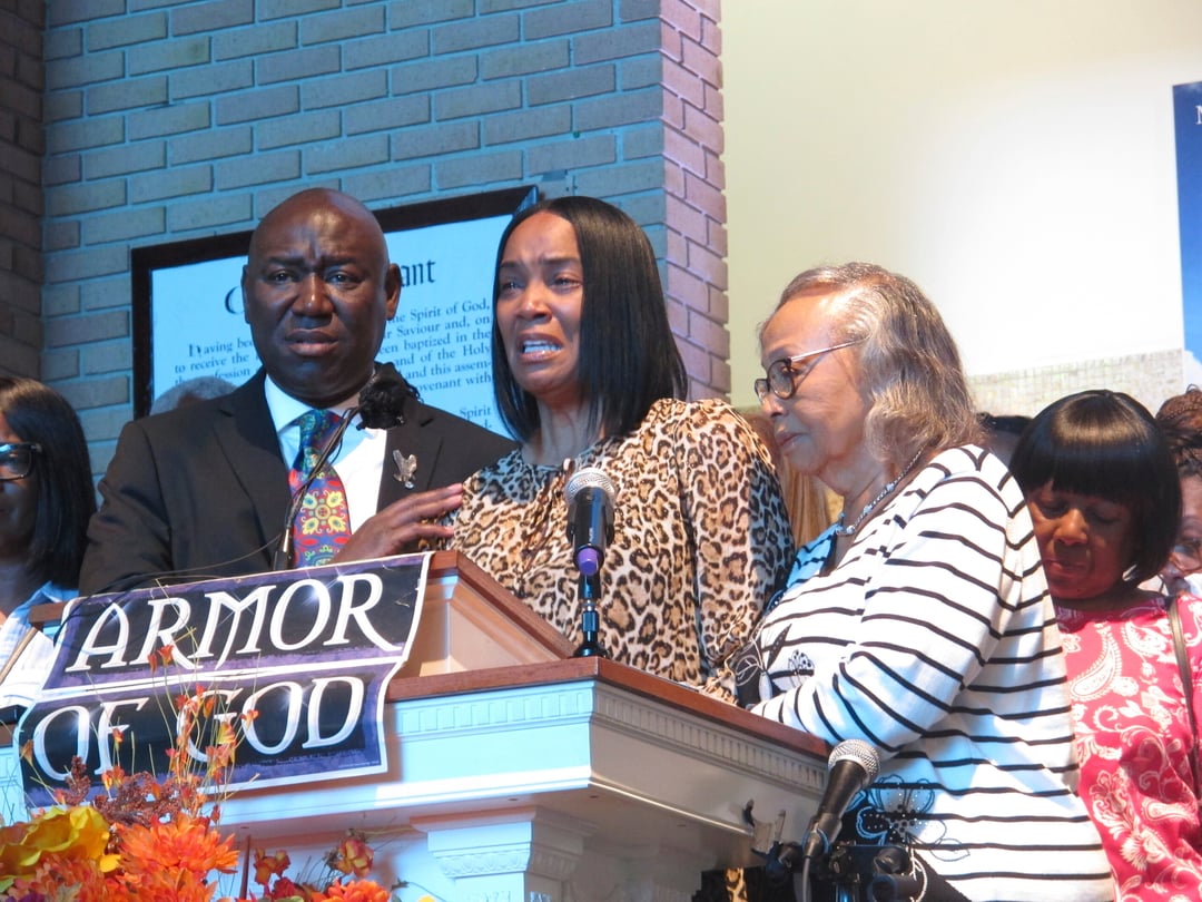 Regina Brinson, center, weeps at a news conference Tuesday, Oct. 22, 2024, while speaking alongside her mother, Katrena Alexander and attorney Ben Crump during a news conference in Jacksonville, Fla.