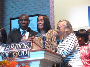 Regina Brinson, center, weeps at a news conference Tuesday, Oct. 22, 2024, while speaking alongside her mother, Katrena Alexander and attorney Ben Crump during a news conference in Jacksonville, Fla.
