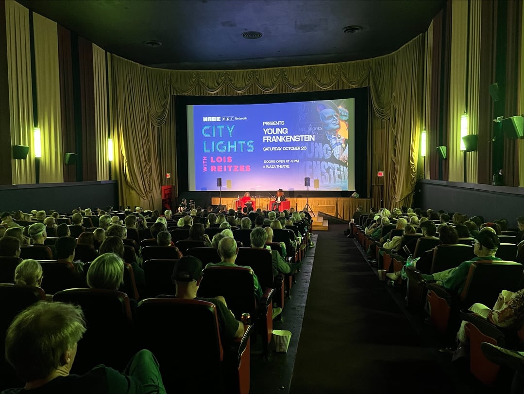 A movie theater with the City Lights logo projected on screen.