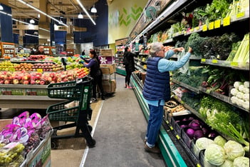 People shop at a grocery store