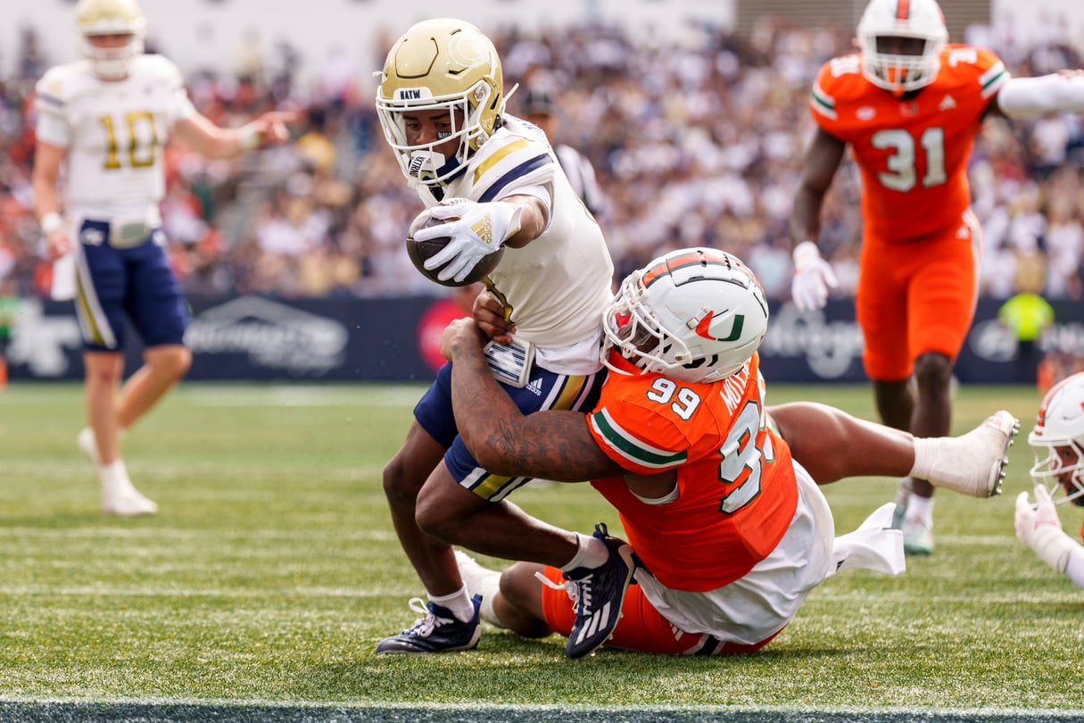 Georgia Tech wide receiver Malik Rutherford, left, reaches over the goal line while being tackled by Miami defensive lineman Ahmad Moten Sr.