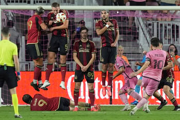 Several Atlanta United players jump in the air next to the goal.
