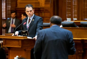 Christian Coomer, left, answers a question from Rep. Al Williams, D-Midway, during a legislation debate on the House floor, March 25, 2015, in Atlanta.