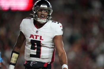 Michael Penix Jr. wears a #9 Atlanta Falcons jersey and protective helmet during a game.
