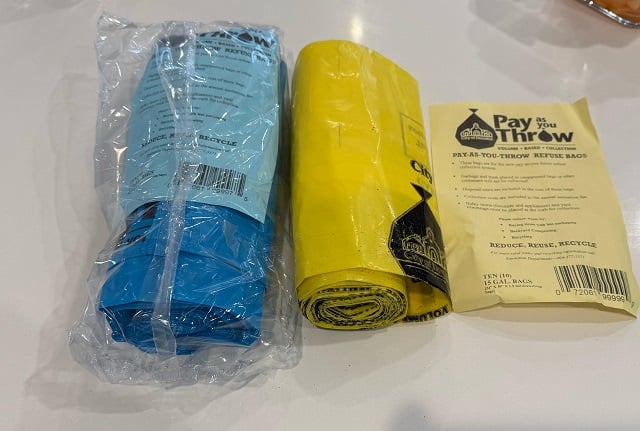A roll of blue bags and a roll of yellow bags.
