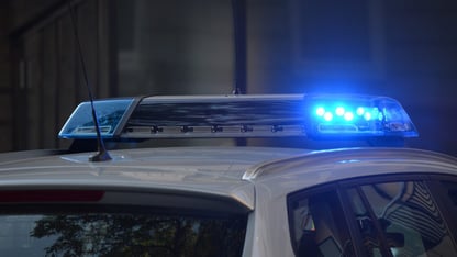 A blue flashing light on top of a police car