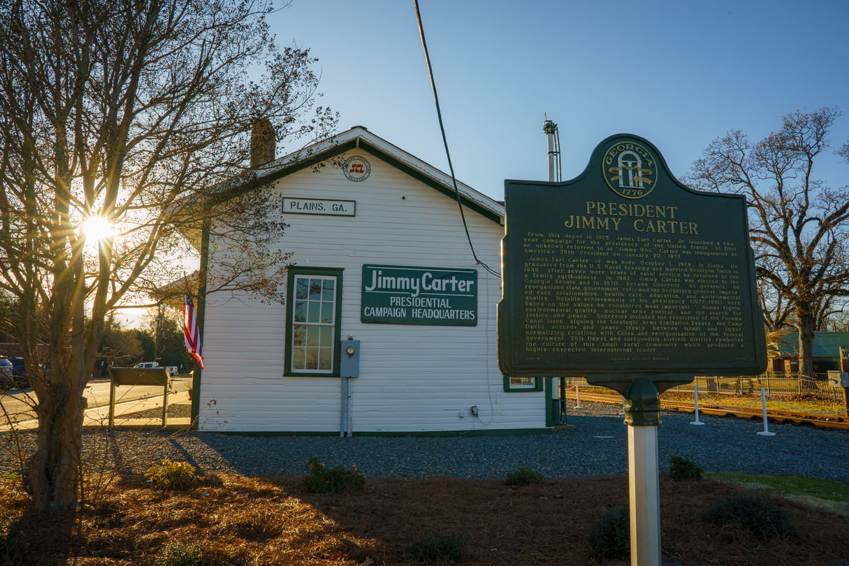The sun begins to set behind the presidential campaign headquaters of former President Jimmy Carter in his hometown of Plains, Ga.