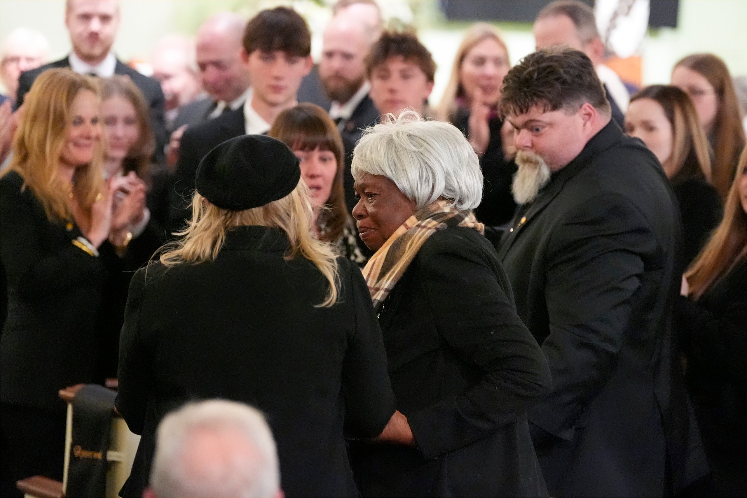 Amy Carter greets Mary Prince during the funeral service for former President Jimmy Carter at Maranatha Baptist Church.