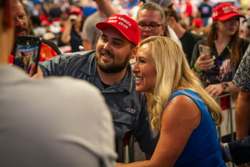 U.S. House Rep. Marjorie Taylor Greene takes a selfie with a supporter at a rally for former President Donald Trump on Aug. 3, 2024.