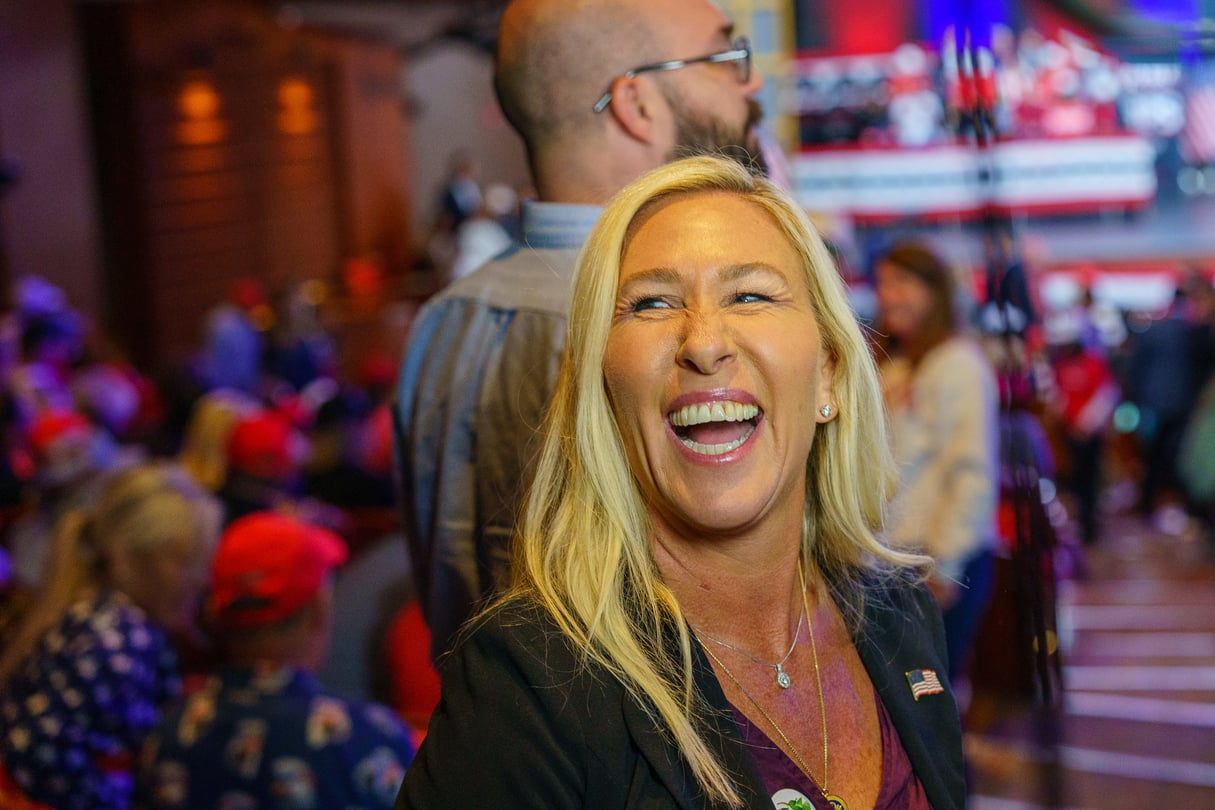 Marjorie Taylor Greene laughs at a rally