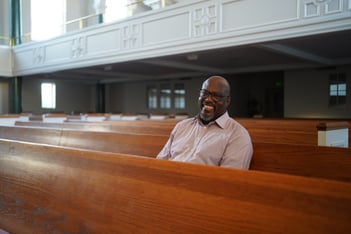 Rev. Cedrick Von Jackson, pastor of West Hunter Street Baptist Church, sits in the center of the church's sanctuary.