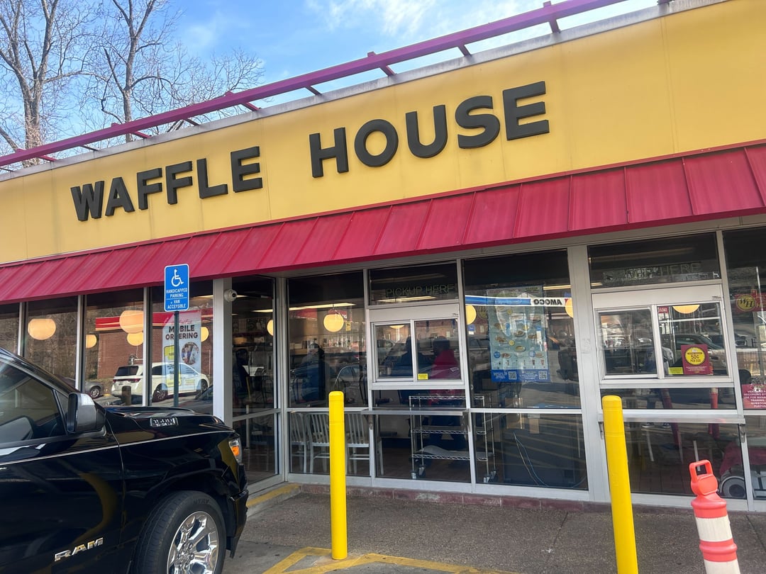 The yellow and red storefront of Waffle House.