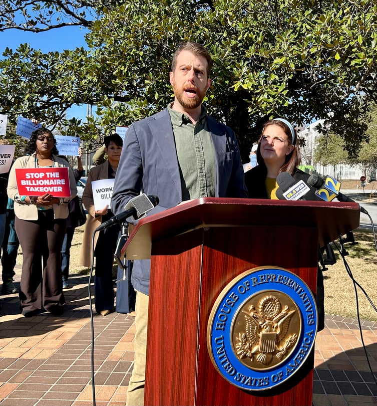 Ryan Sloane, one of hundreds of federal employees fired from the CDC as the Trump administration slashes the government workforce, speaking at a protest in Atlanta. (Jess Mador/WABE)