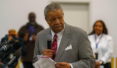 Robb Pitts holds a microphone.