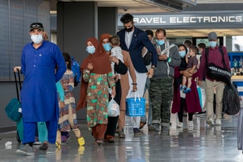 Refugees walk through the airport